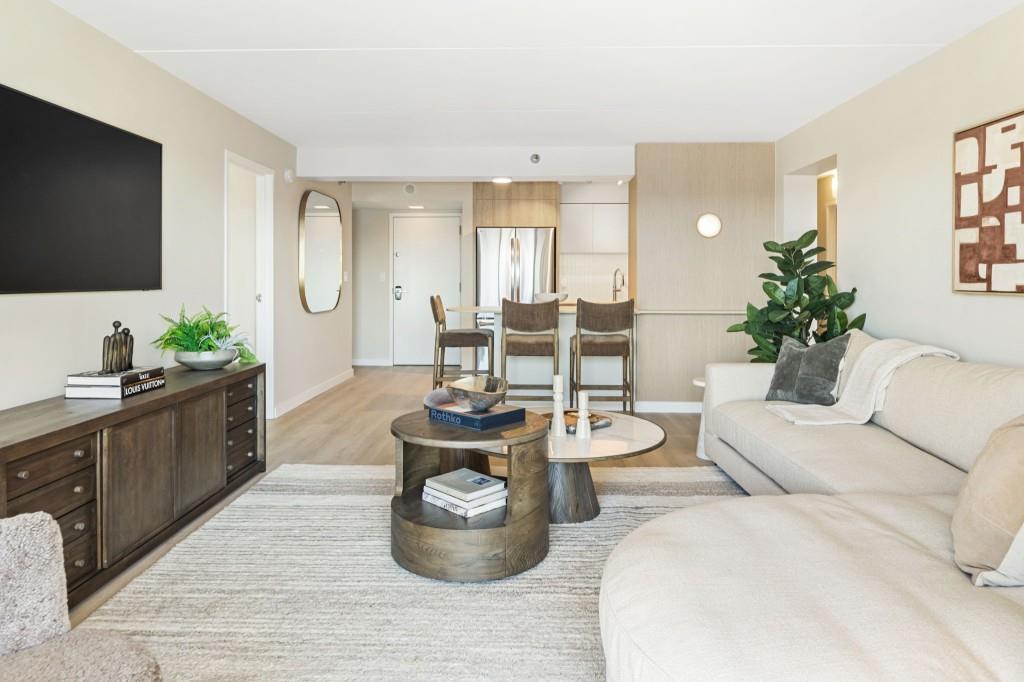 2460 Peachtree Road Northeast, Unit 1105 Atlanta, GA 30305 - Photo 14 of 51 a living room with furniture a flat screen tv and a large window