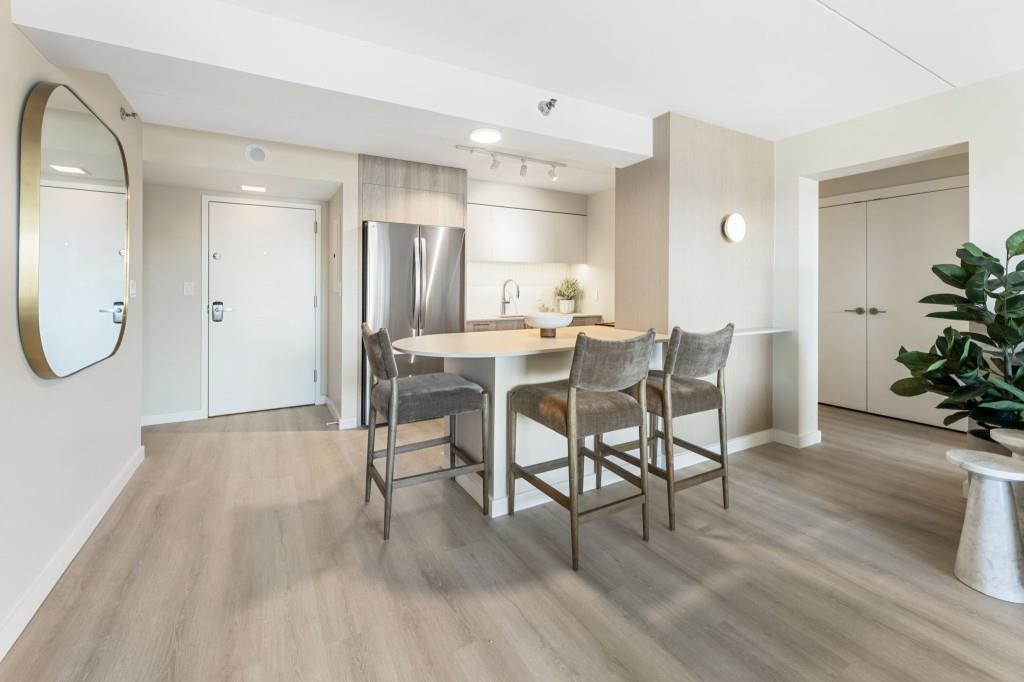 2460 Peachtree Road Northeast, Unit 1105 Atlanta, GA 30305 - Photo 2 of 51 a view of a dining room with furniture and wooden floor