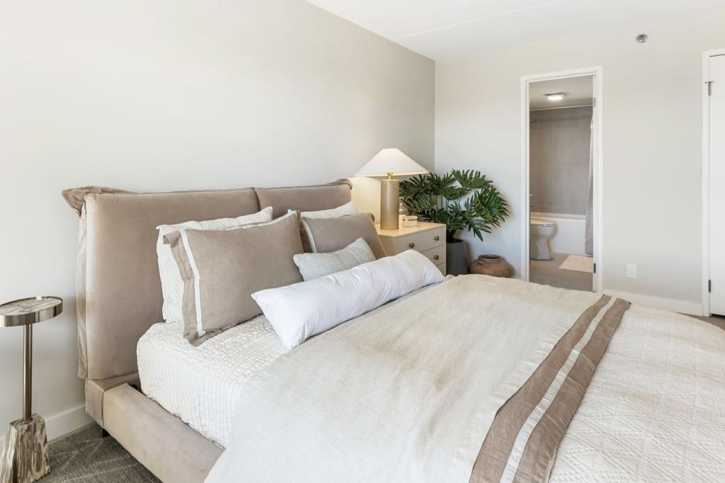 2460 Peachtree Road Northeast, Unit 1105 Atlanta, GA 30305 - Photo 27 of 51 a bedroom with a bed and a potted plant