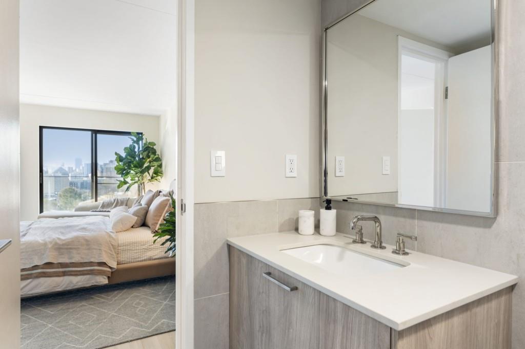 2460 Peachtree Road Northeast, Unit 1105 Atlanta, GA 30305 - Photo 30 of 51 a bathroom with a sink and a mirror