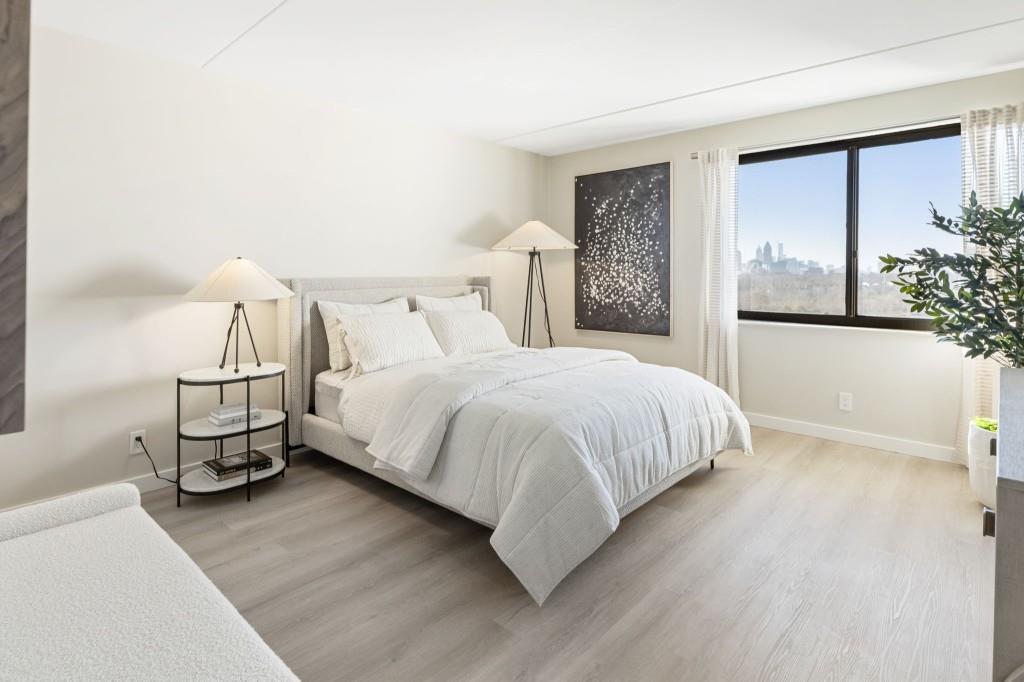 2460 Peachtree Road Northeast, Unit 1105 Atlanta, GA 30305 - Photo 32 of 51 a large bed sitting in a bedroom next to a window