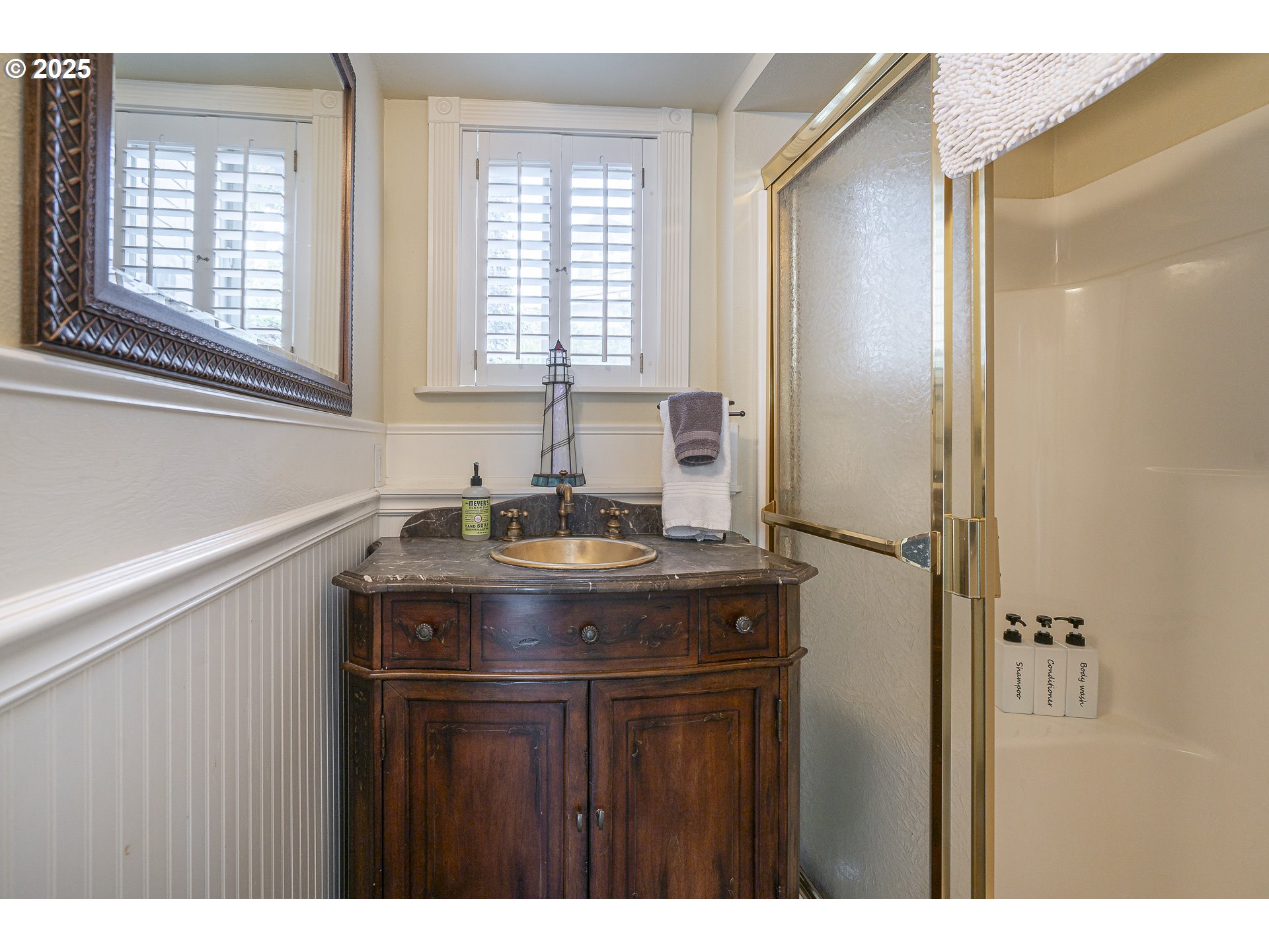 2325 Southwest Bard Loop Lincoln City, OR 97367 - Photo 12 of 28 a bathroom with a sink and a mirror