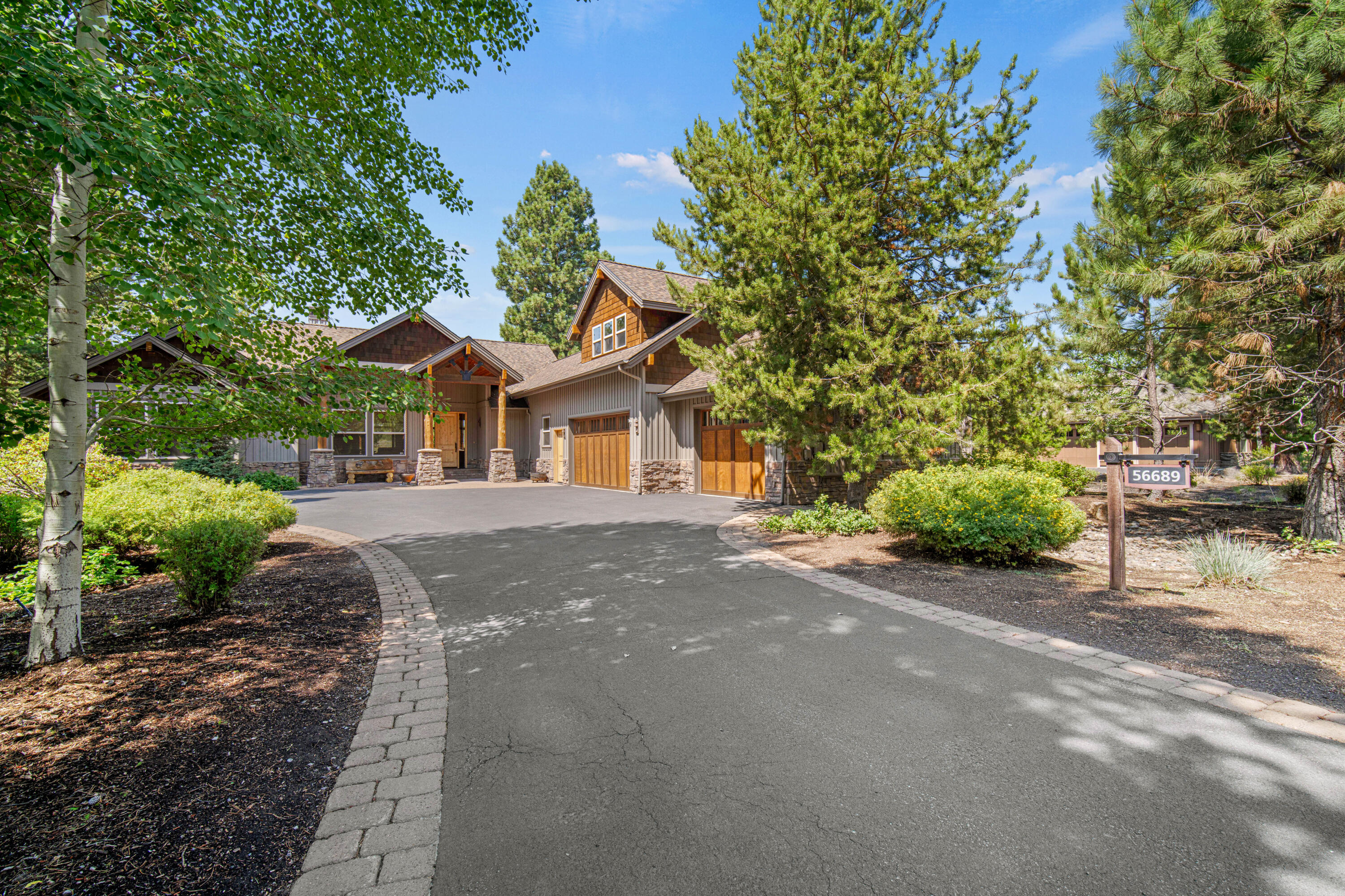 56689 Dancing Rock Loop Bend, OR 97707 - Photo 3 of 51 a front view of a house with a yard and trees
