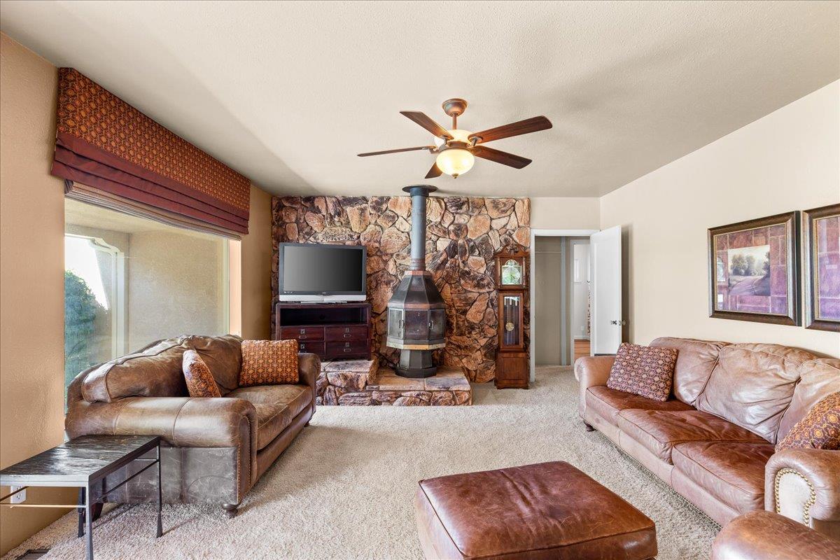 4701 Lone Tree Road Valley Home, CA 95361 - Photo 12 of 59 a living room with furniture ceiling fan and a rug