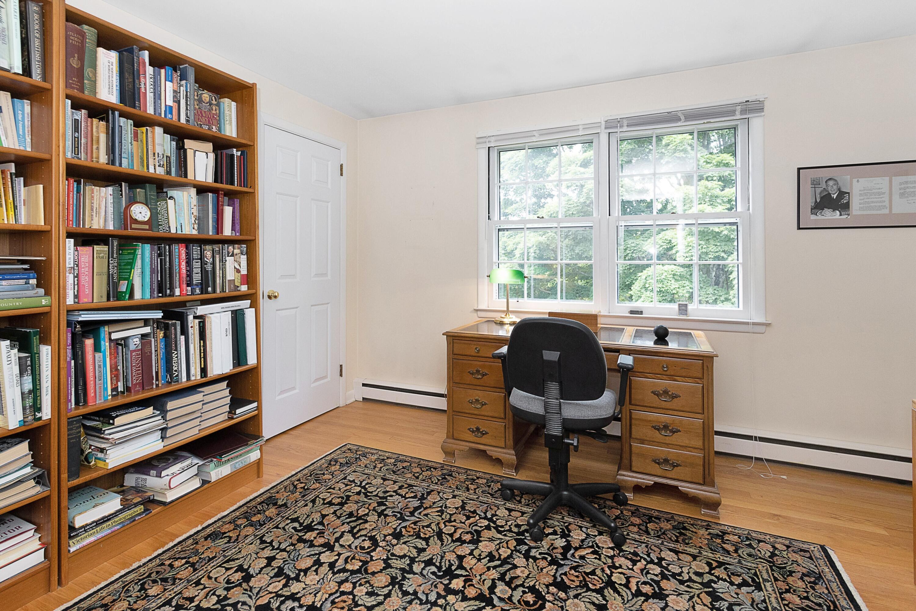 10 Wilson Ridge Road East Darien, CT 06820 - Photo 23 of 25 a view of a workspace with furniture and a bookshelf
