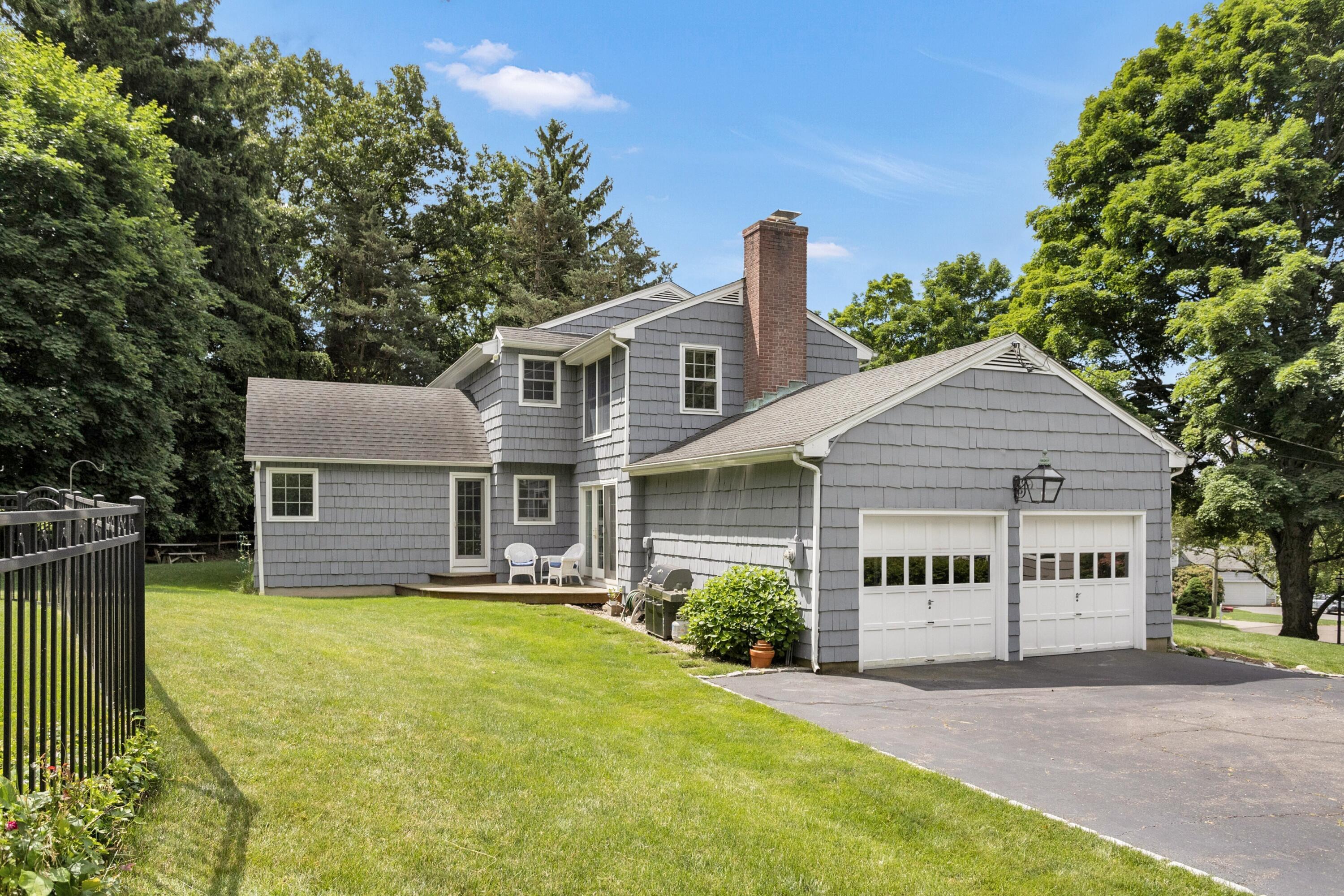 10 Wilson Ridge Road East Darien, CT 06820 - Photo 24 of 25 a view of a house with a yard and potted plants