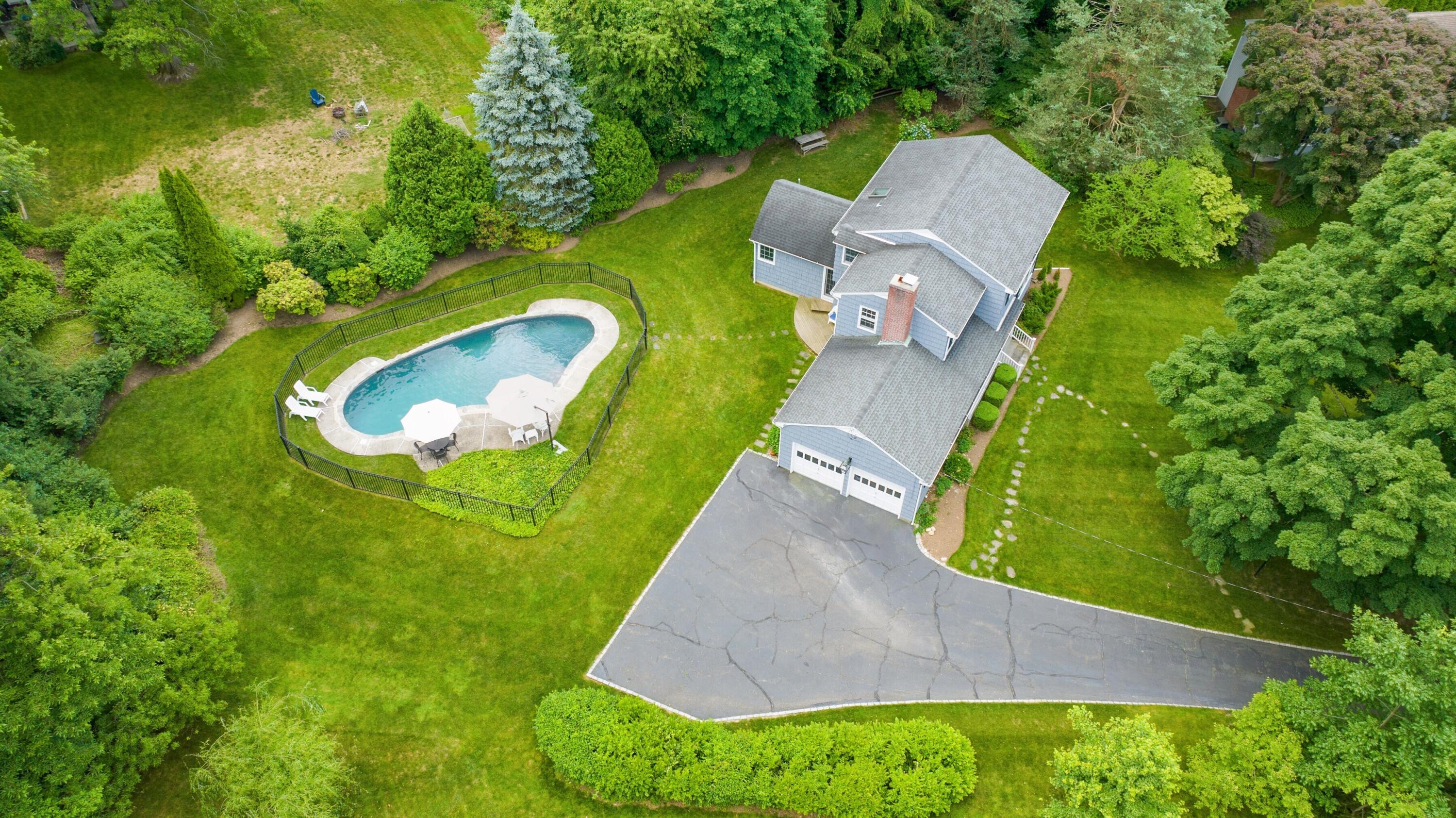 10 Wilson Ridge Road East Darien, CT 06820 - Photo 6 of 25 an aerial view of a house with a garden and trees