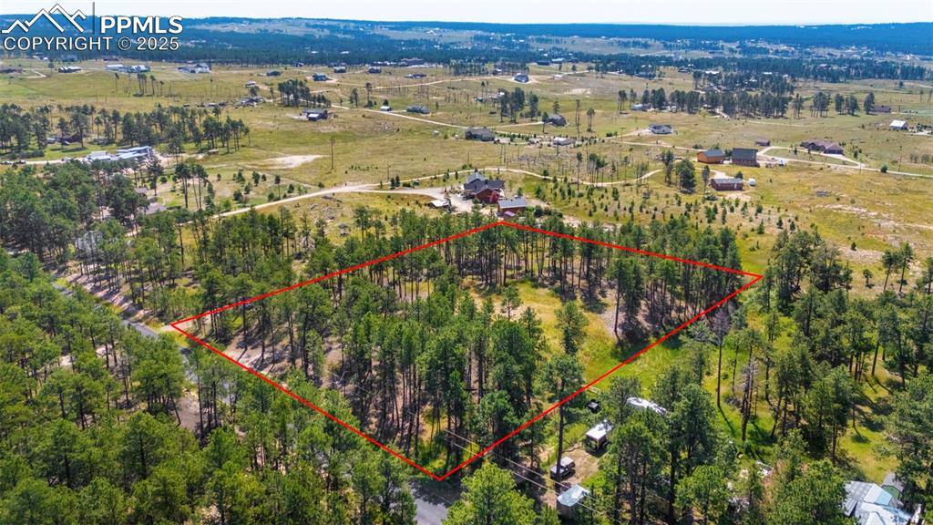 6225 Vessey Road Colorado Springs, CO 80908 - Photo 2 of 8 an aerial view of residential houses with outdoor space and trees