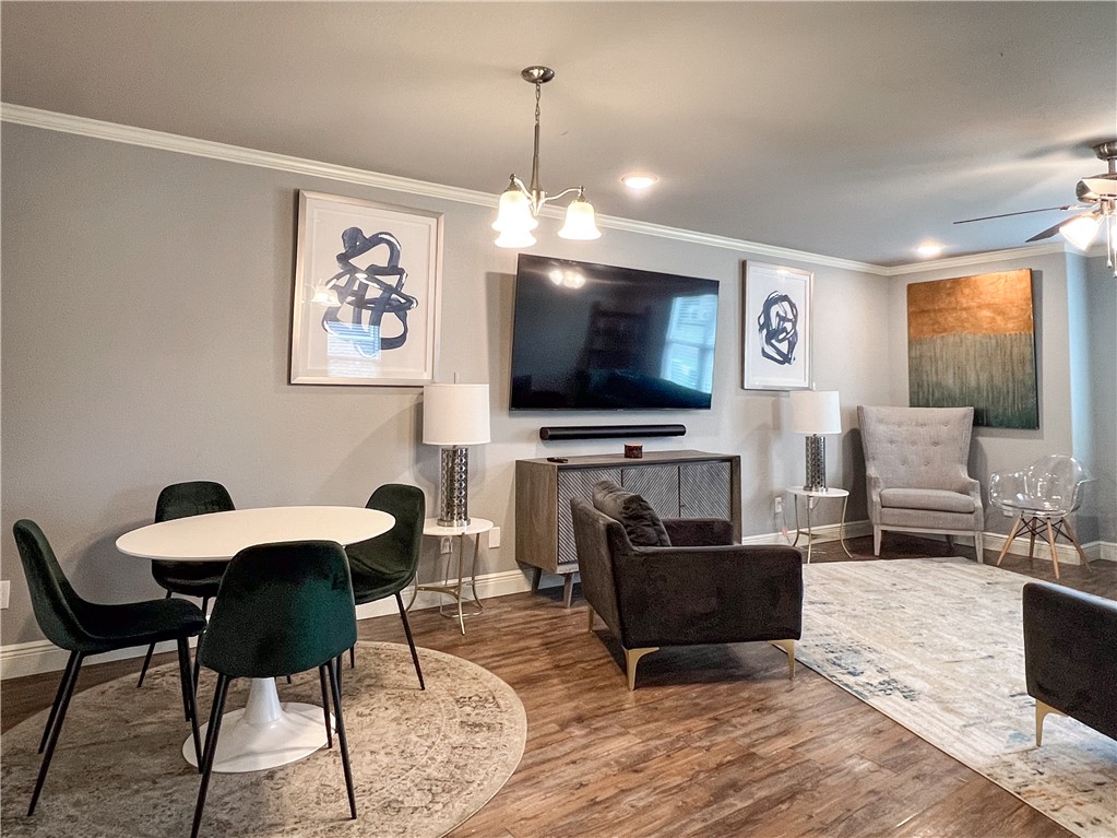 1275 North Rupple Road Fayetteville, AR 72704 - Photo 2 of 20 Open-concept living area featuring wood-finish flooring, crown molding, and recessed lighting