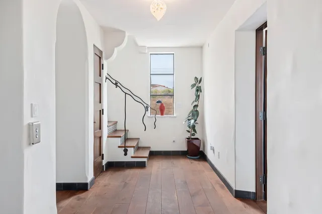 a bed sitting in a bedroom next to a window