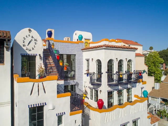 a view of multiple house with large windows and a yard