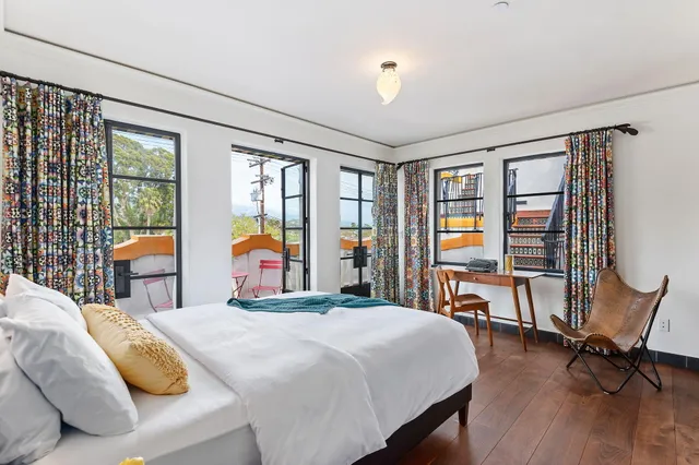 a spacious bedroom with a bed and a table