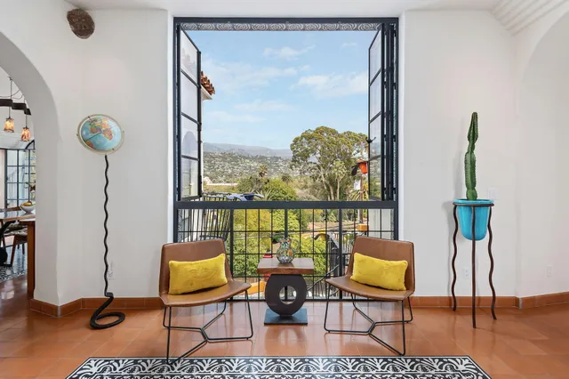 a view of a livingroom with furniture window and wooden floor