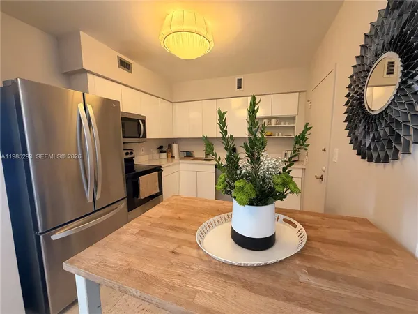 a kitchen with a refrigerator and a sink