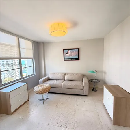 a living room with furniture a window and a couch