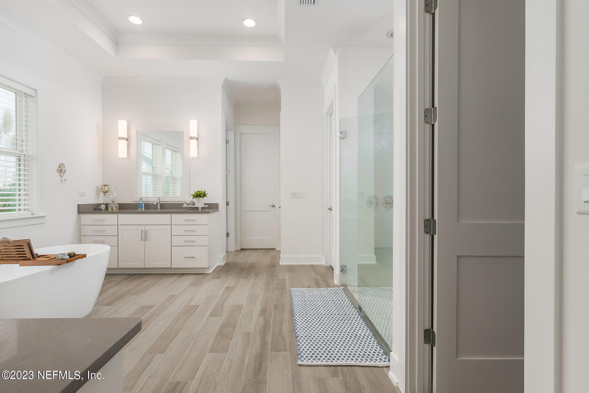 57 Topside Dr. St. Johns, FL 32259 - Photo 18 of 46 a bathroom with a sink a toilet a mirror and a tub