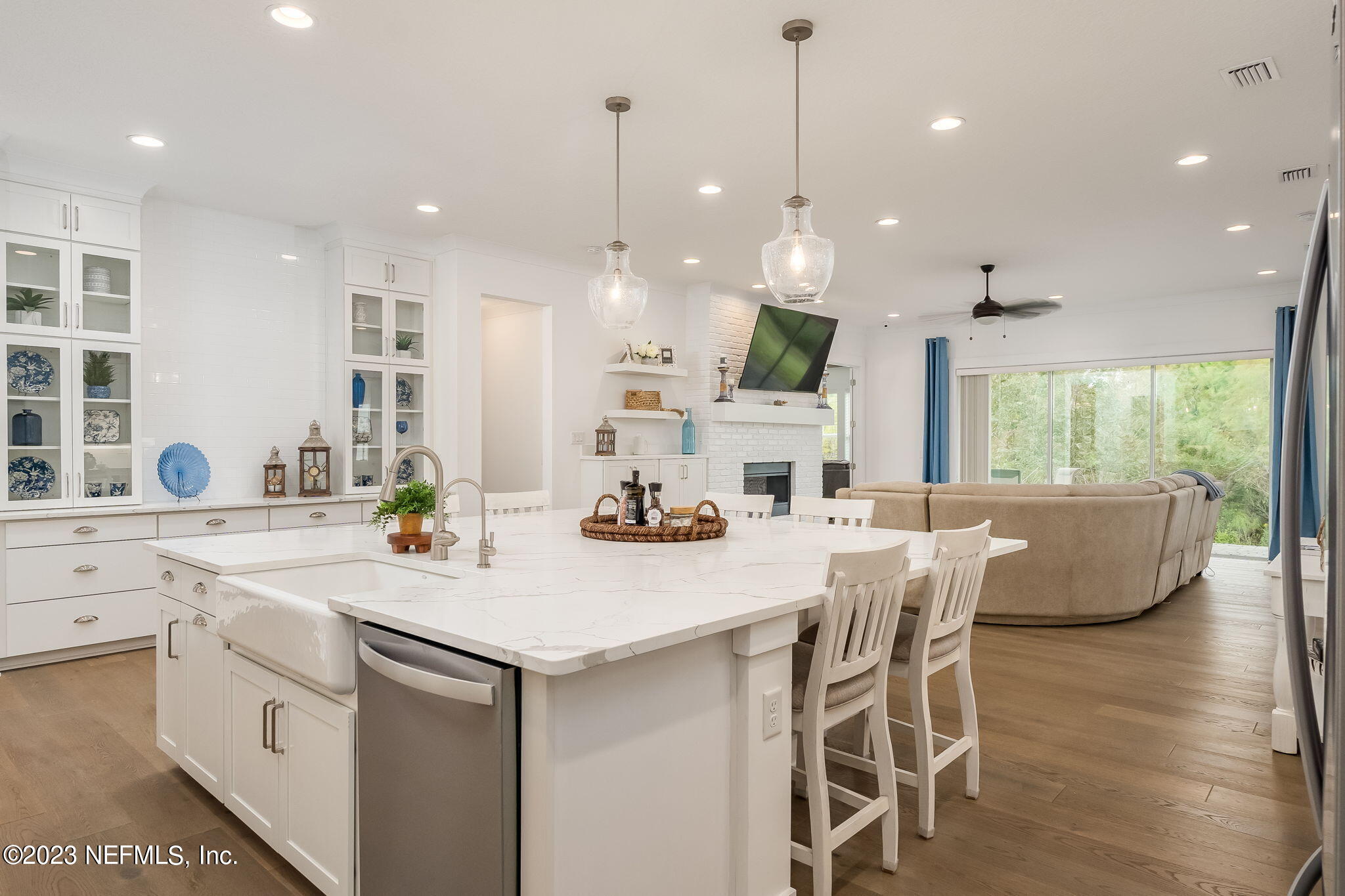 57 Topside Dr. St. Johns, FL 32259 - Photo 8 of 46 a kitchen with stainless steel appliances kitchen island granite countertop a stove a sink a dining table and chairs with wooden floor