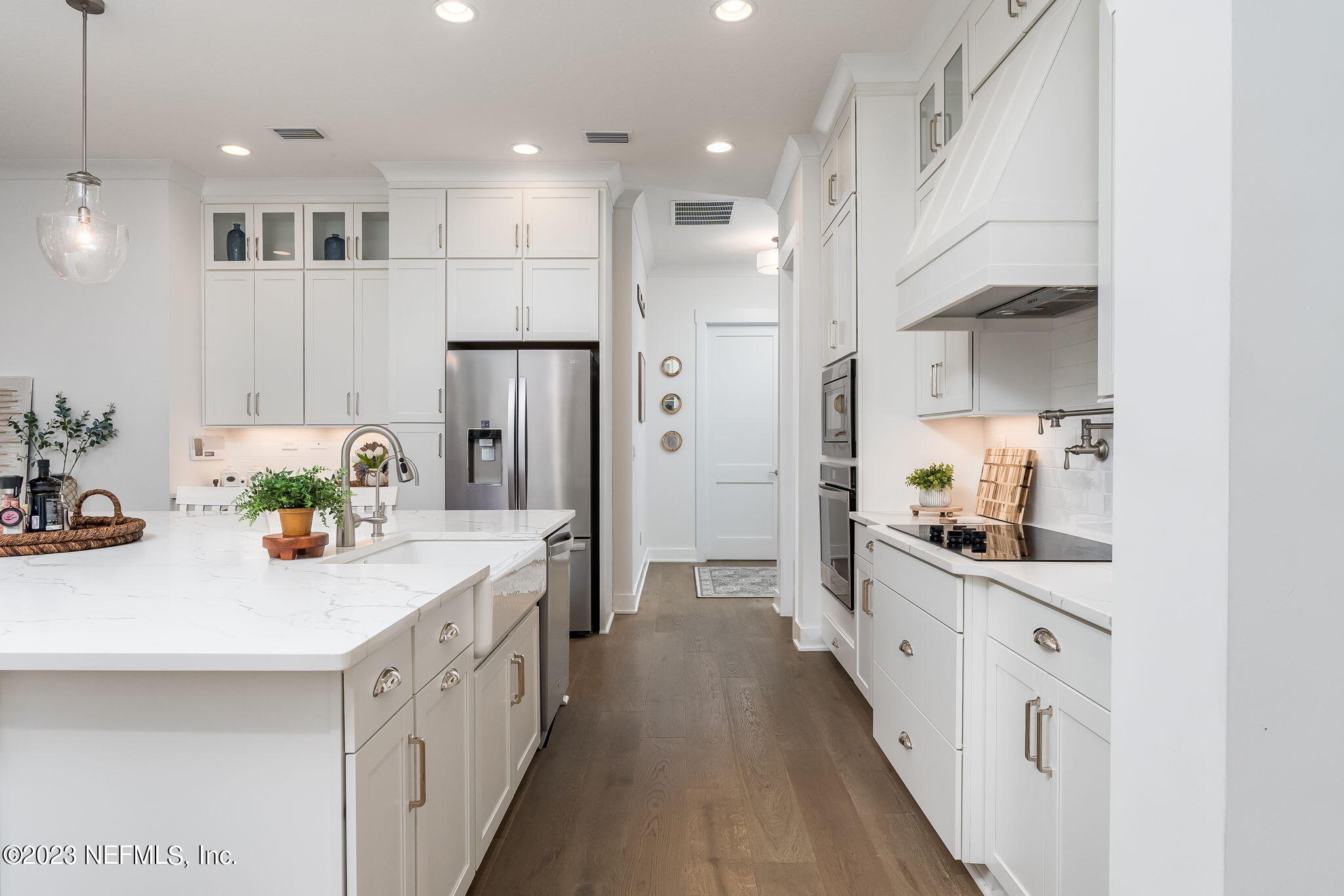 57 Topside Dr. St. Johns, FL 32259 - Photo 10 of 46 a kitchen with kitchen island white cabinets and refrigerator