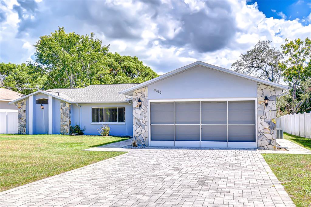a view of a house with a yard and garage