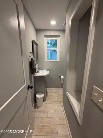 a bathroom with a sink a mirror and a toilet