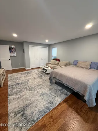 a bedroom with a bed and a large mirror