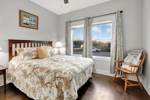 a large bed sitting in a bedroom next to a window