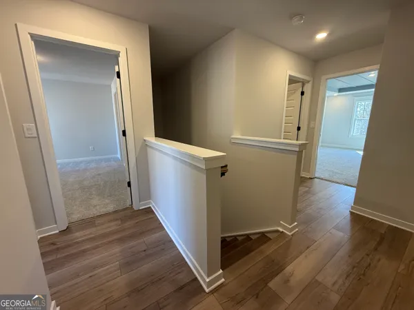 an empty room with closet and wooden floor