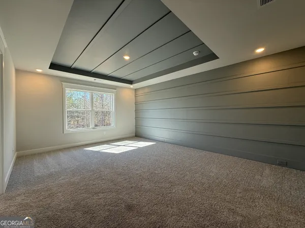 a spacious bathroom with a double vanity sink a mirror and a bathtub