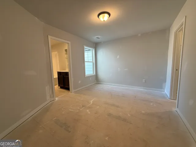 an empty room with closet area