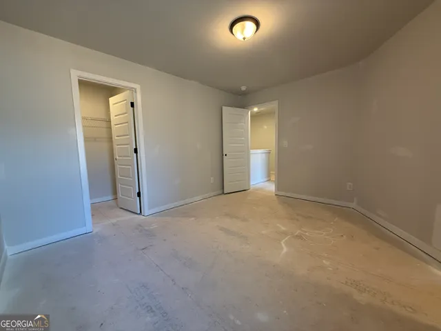 a spacious bathroom with a bathtub sink and mirror
