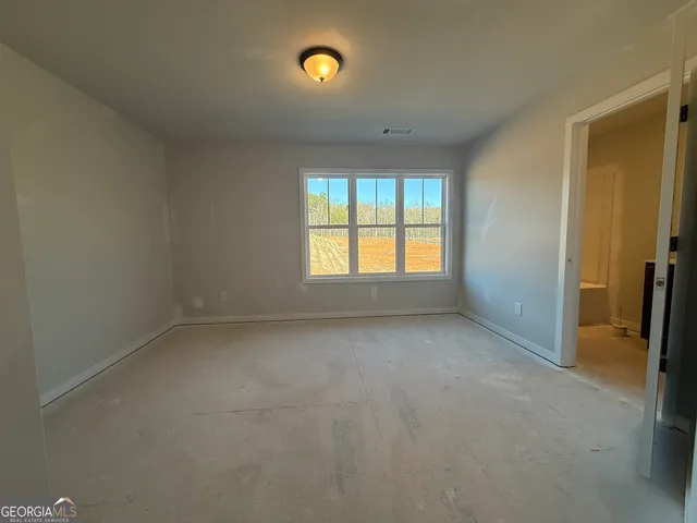 an empty room with closet and a bathroom