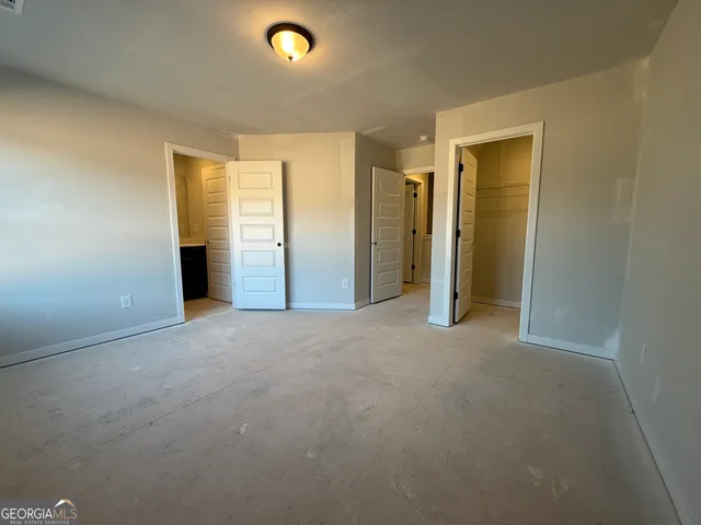 an empty room with closet area