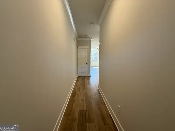 a view of a kitchen with wooden floor and stairs