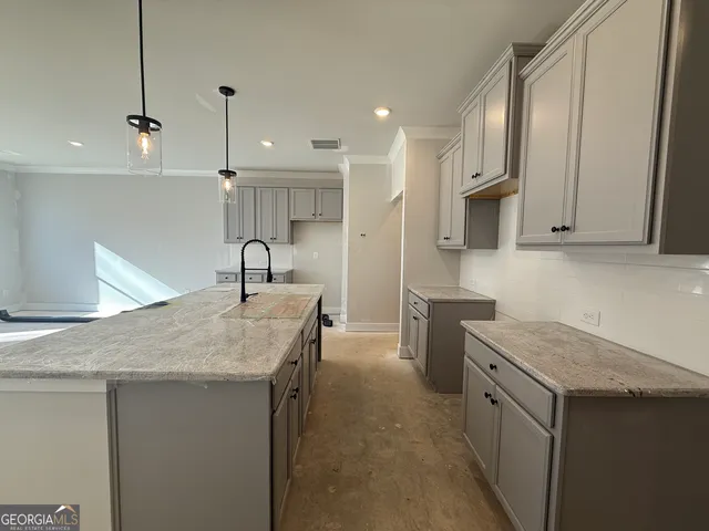 a kitchen with a sink stove and cabinets