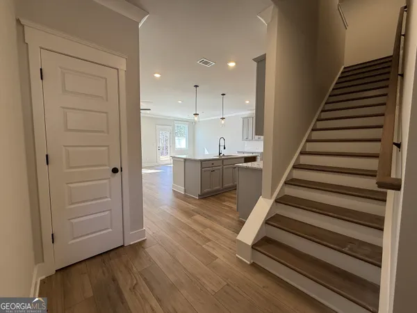 a kitchen with a sink cabinets and wooden floor