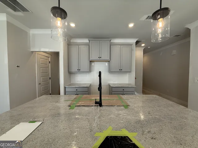 a view of a kitchen with furniture and a refrigerator