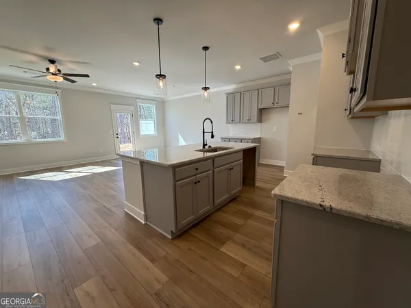 a view of a kitchen with a sink and refrigerator