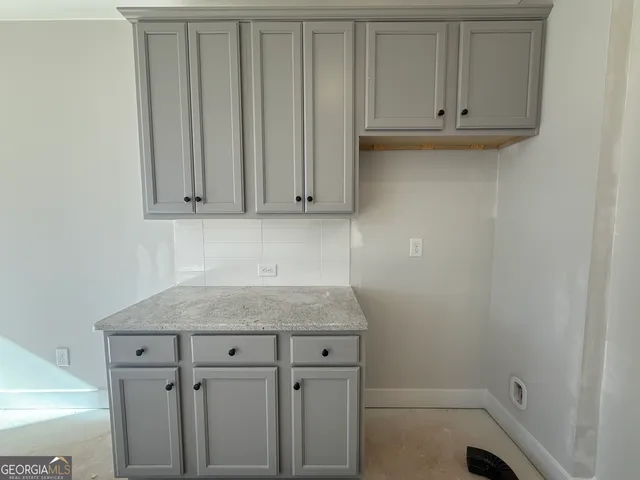 a view of a storage and utility room with cabinets