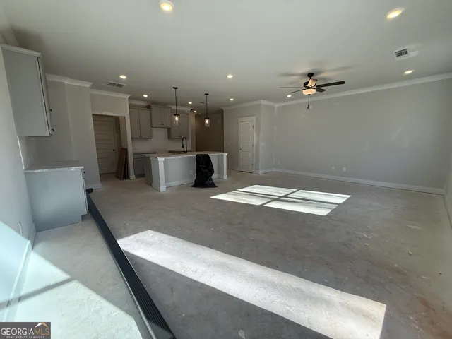 a view of kitchen with a refrigerator and a sink