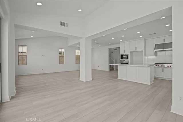 a view of kitchen with wooden cabinet and refrigerator