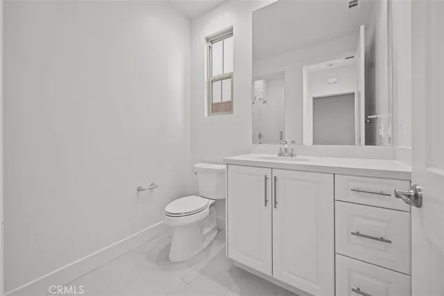 a bathroom with a sink toilet and vanity