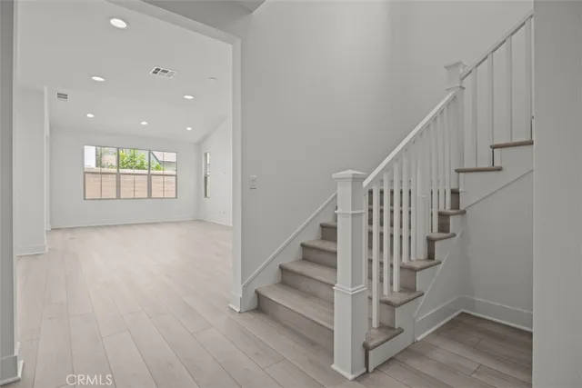 a view of entryway and hall with wooden floor