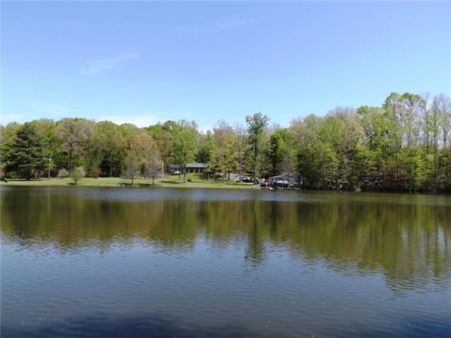 1278 Spence Road Camden, TN 38320 - Photo 8 of 20 a view of a lake with a mountain in the background