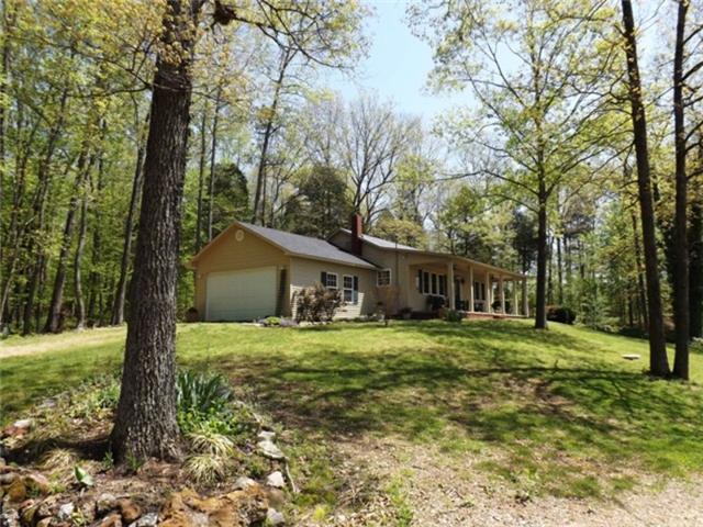 1278 Spence Road Camden, TN 38320 - Photo 9 of 20 a yellow house in middle of the forest