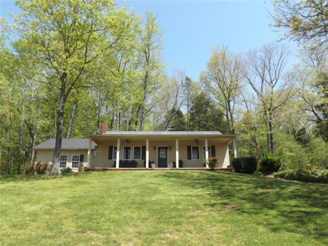 1278 Spence Road Camden, TN 38320 - Photo 10 of 20 a front view of a house with a garden