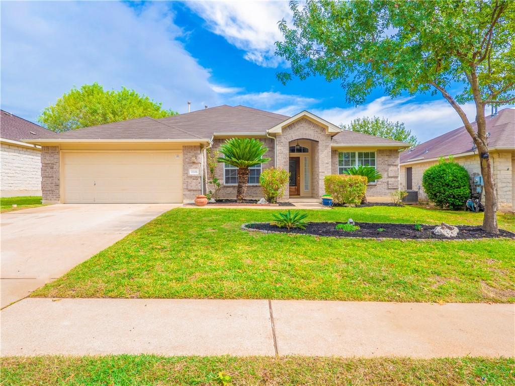 2206 Boneset Trail Round Rock, TX 78665 - Photo 1 of 35 a front view of a house with a yard and potted plants