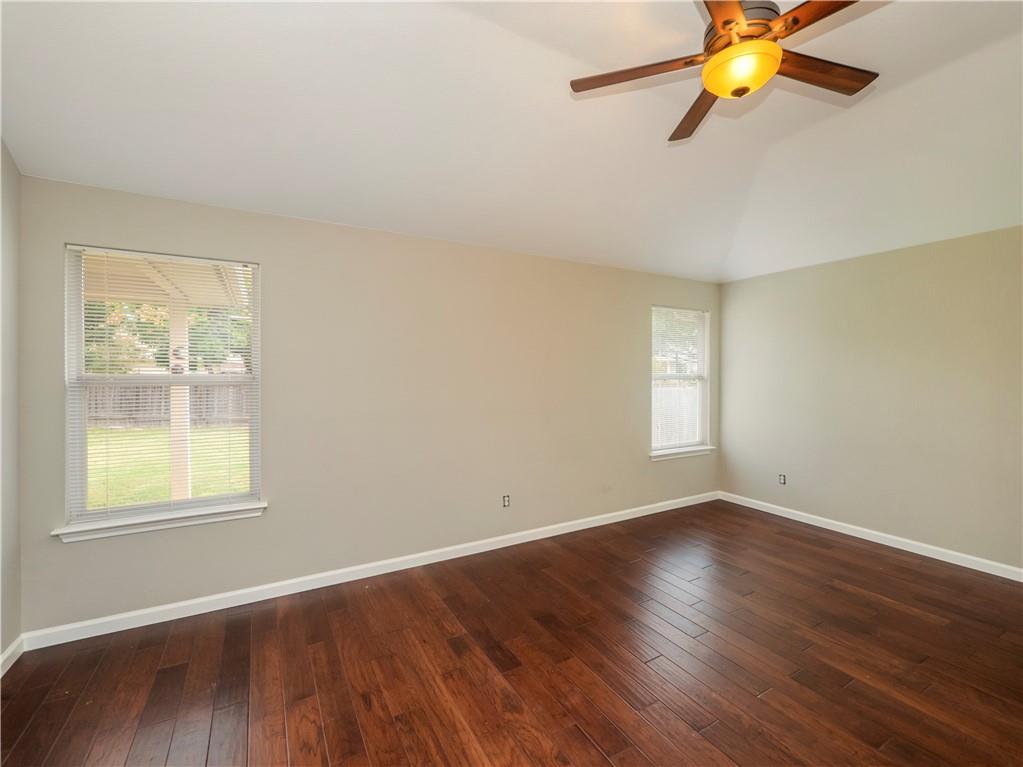 2206 Boneset Trail Round Rock, TX 78665 - Photo 17 of 35 a view of an empty room with wooden floor and a window