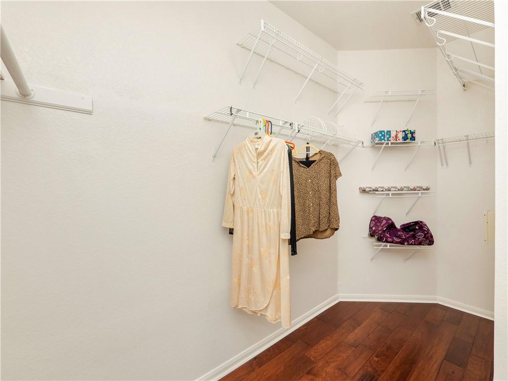 2206 Boneset Trail Round Rock, TX 78665 - Photo 21 of 35 a view of walk in closet with clothes and shoes