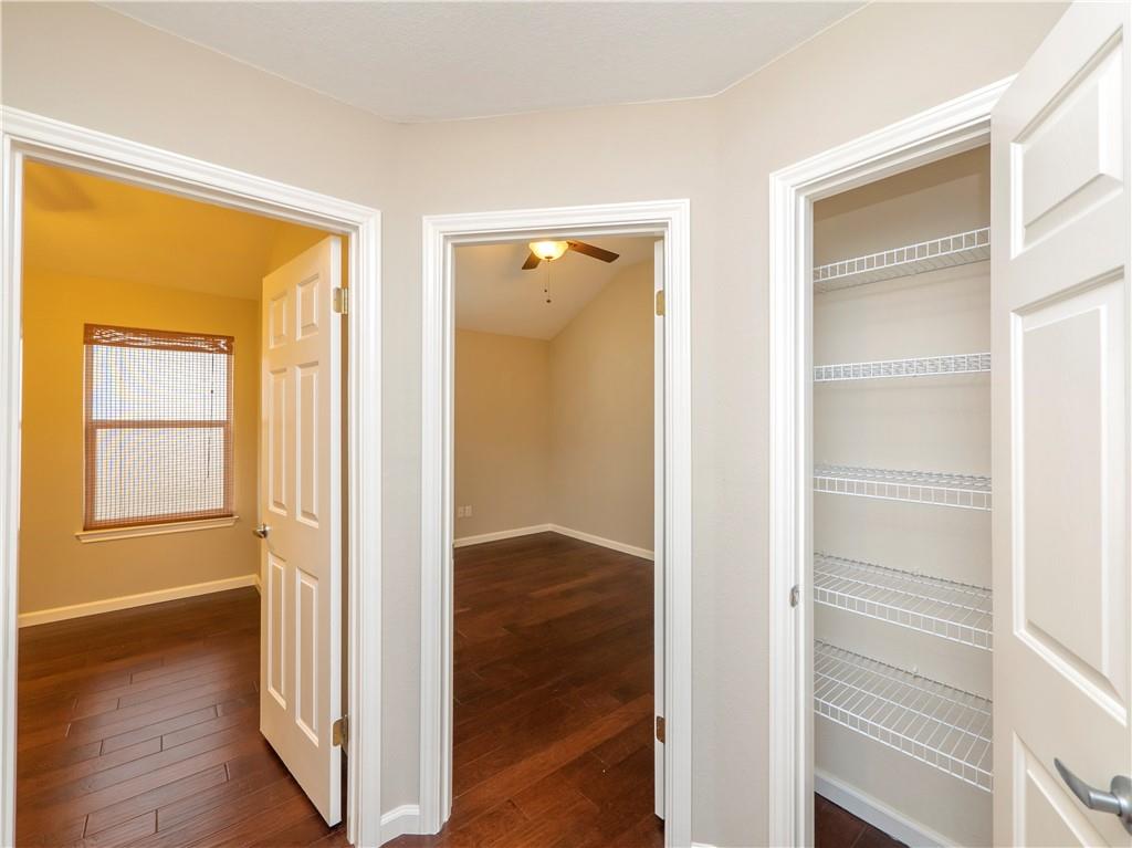 2206 Boneset Trail Round Rock, TX 78665 - Photo 24 of 35 a view of an empty room with wooden floor and a window