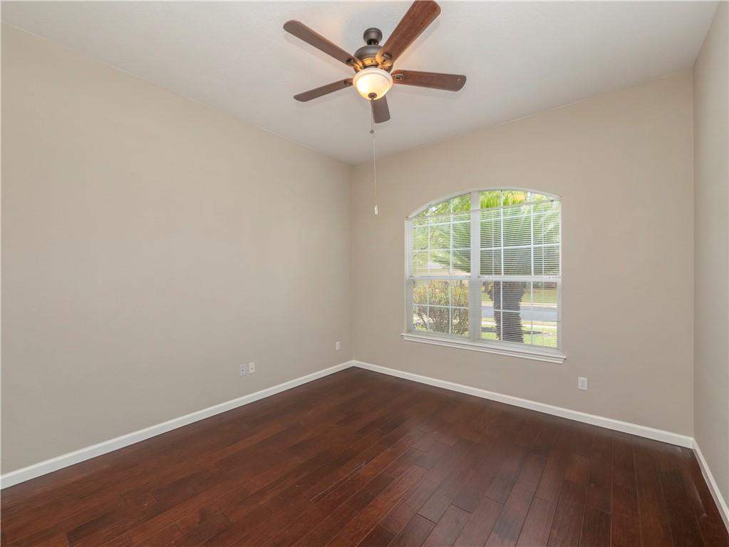 2206 Boneset Trail Round Rock, TX 78665 - Photo 25 of 35 an empty room with wooden floor and windows